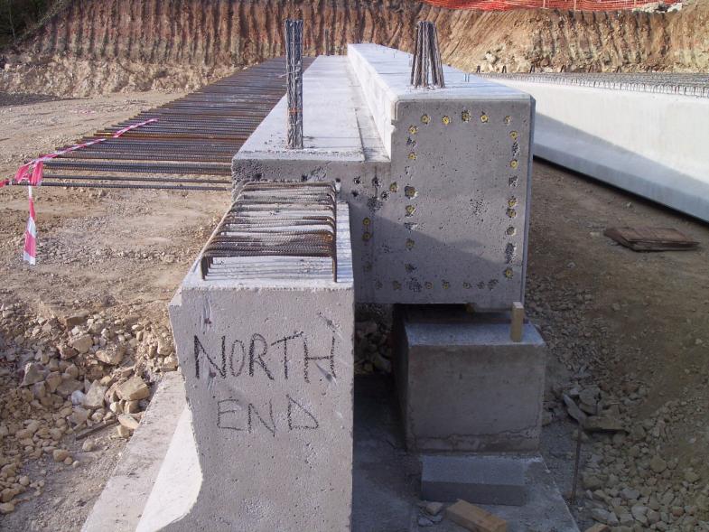 Edge beam off loaded onto temporary concrete plinths