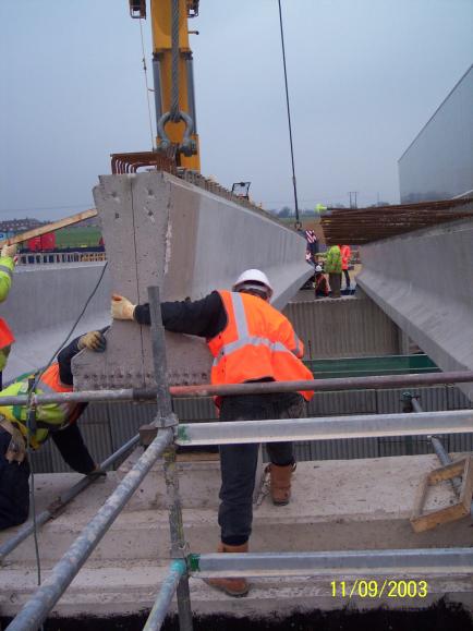 Final beam being installed - Bob Meadows landing the beam with John Masterson on the North abutment 