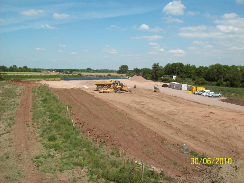 South side - stone being placed and compacted.