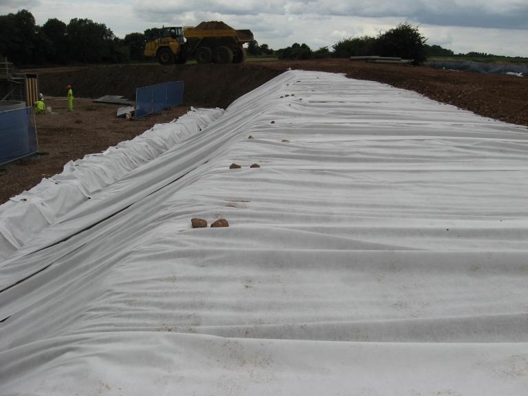 6F5 being placed on the top of the platform - geotextile rolled down the embankment to give erosion control.