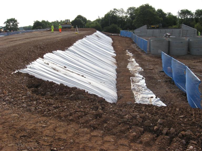 Stone being placed to the top of the south embankment.