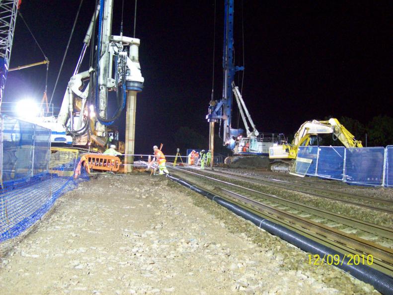 Piling rigs carrying out the pre- bore at track level.