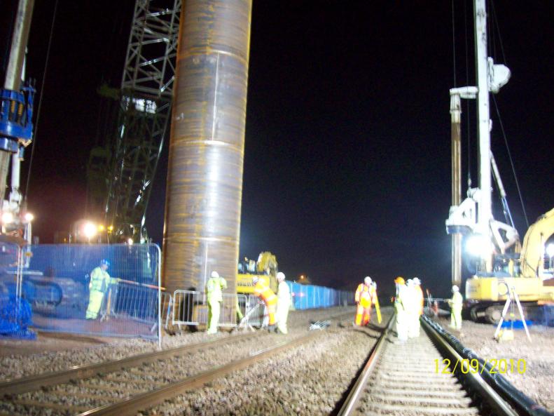 Pile casings being lifted into the pre-bore.