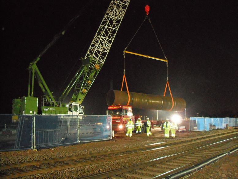 2nd Possession Crane lifting and unloading steel casing.