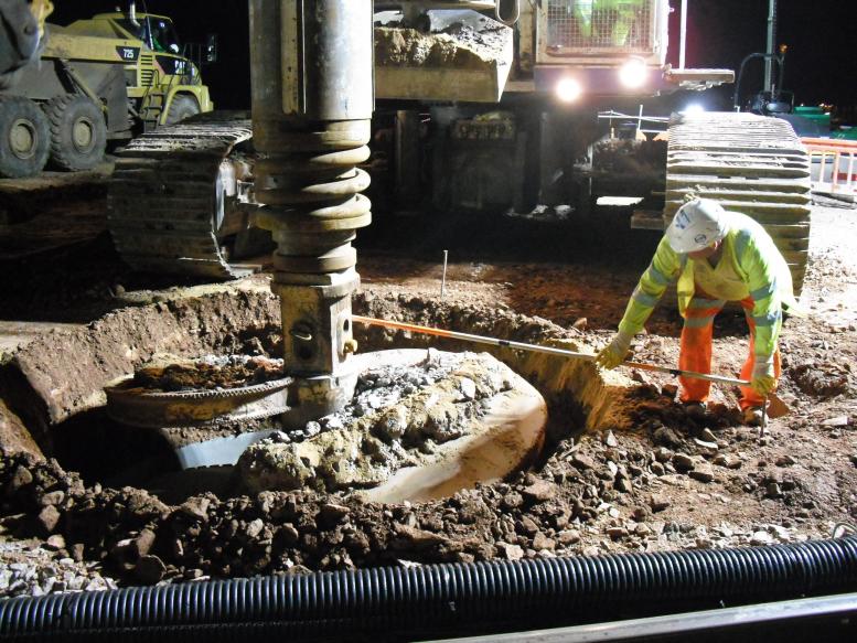 Piling rig being centered up over the pile through the guide wall