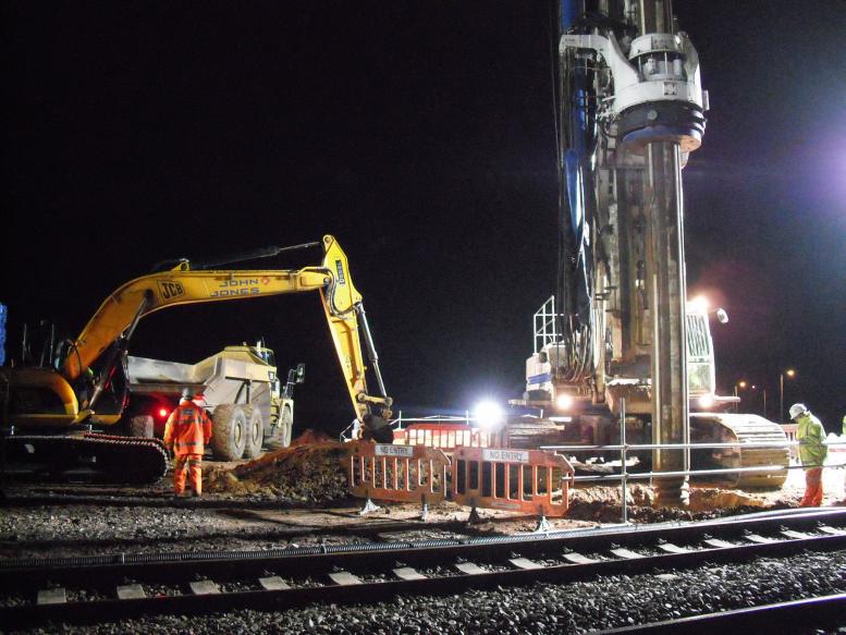 Piling rig drilling the prebore - John Johns cleaning up the spoil from the bore.