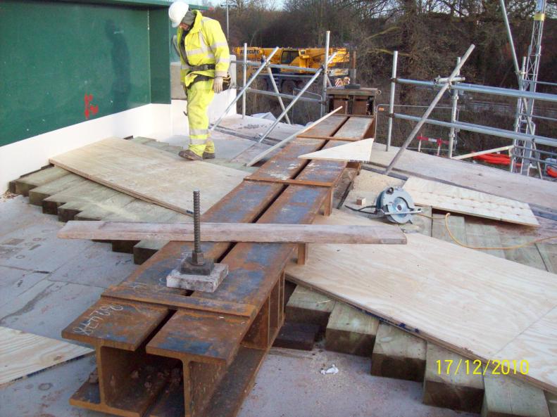 Sleepers and plywood wedge fitted between the carrier beams.