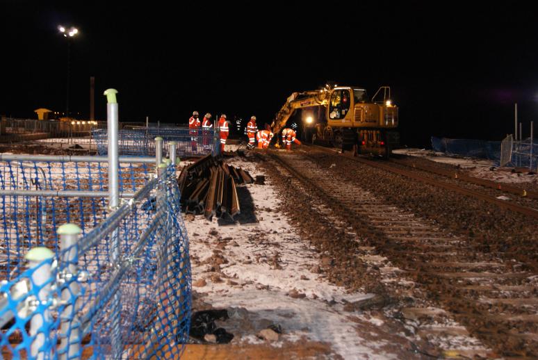 Rails cut up into sections and stockpiled to the side for removal later.