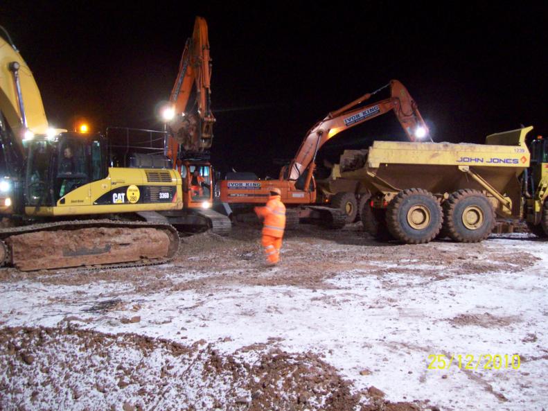 John Jones and Ivor King working together to bulk dig and remove sheet piles.