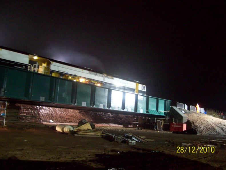 Tamper running across the bridge tamping the track.