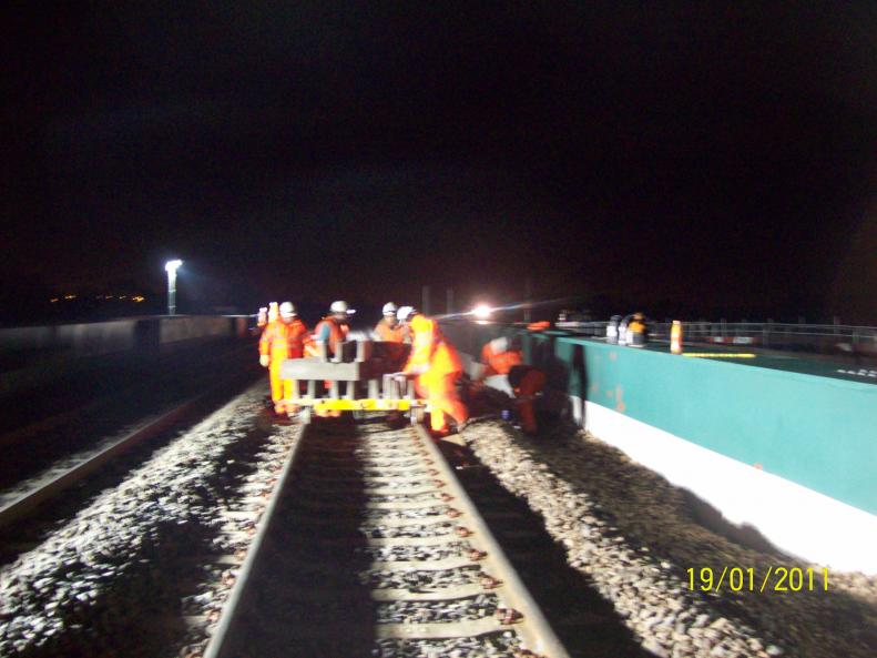 Concrete trough route being installed using trolley.