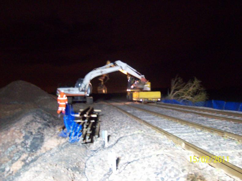 Excavator loading up the RRV and ballast box