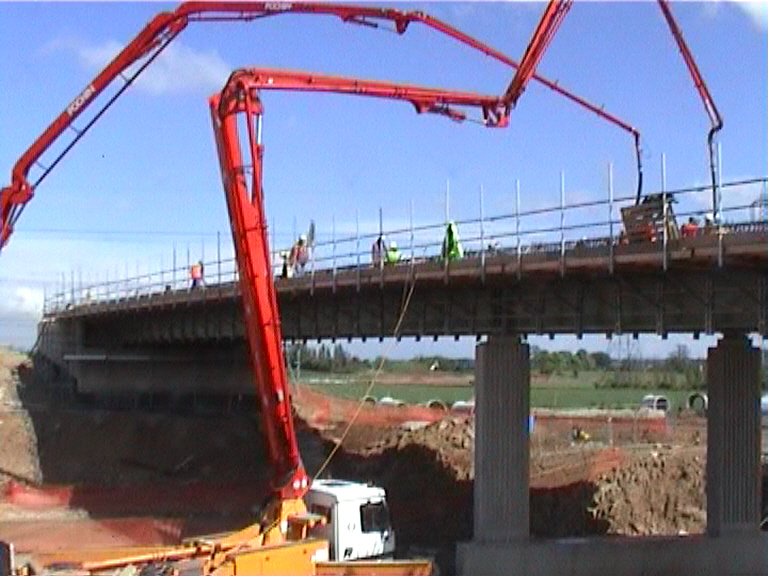 Two concrete pumps placing concrete form the screen walls inwards