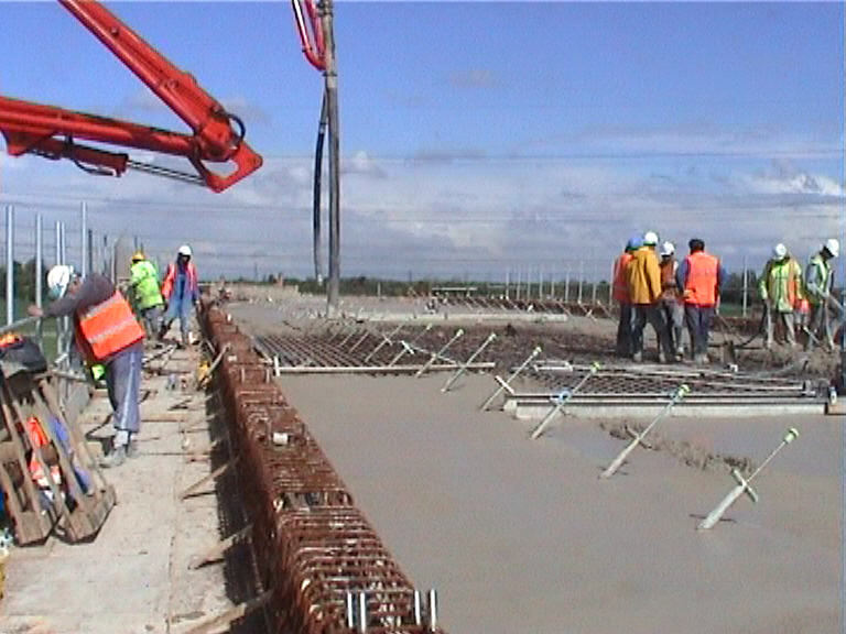 Concrete being placed on the deck form the two ends in