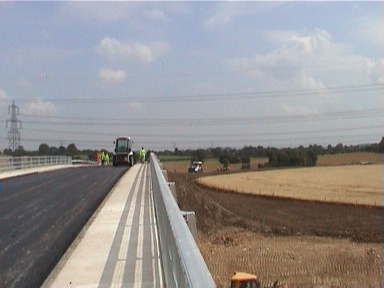 Surface course being laid on the approach and over the deck.