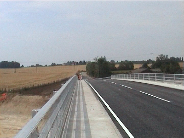 White lines on the bridge. The deck open to traffic.