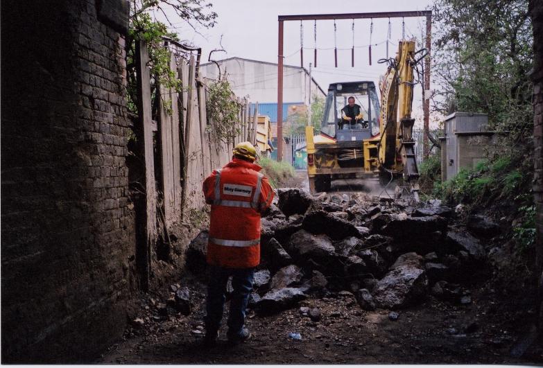 Access Ramp being broken out  down to increase the depth of the road under the structures.