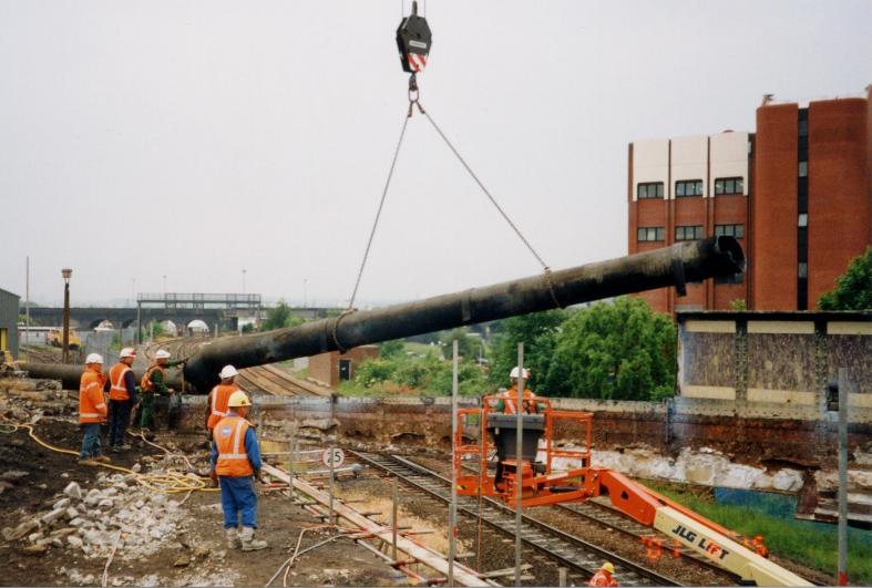 Old gas main being removed from the North side of the bridge
