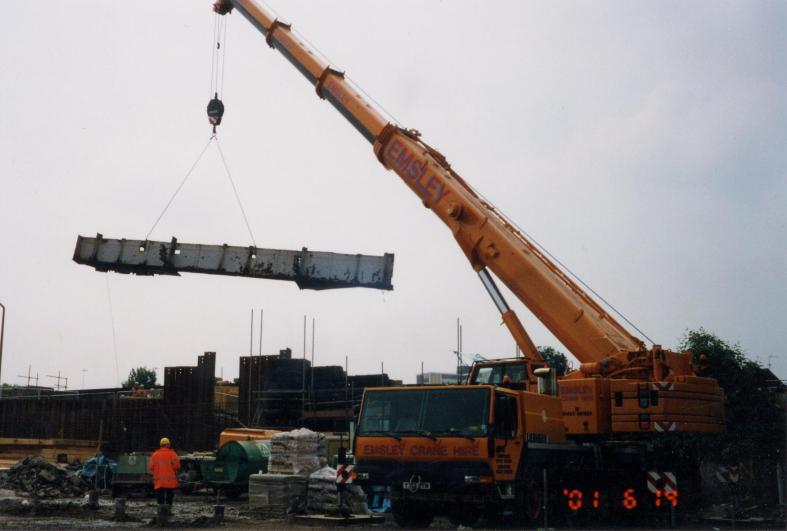 Crane lifting out the bottom section of the girder