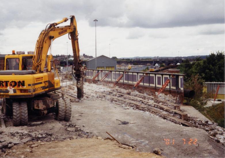 Excavator breaking out the arches on the centre span.