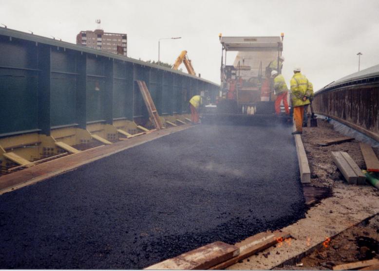 Black top being placed on the North side of the deck