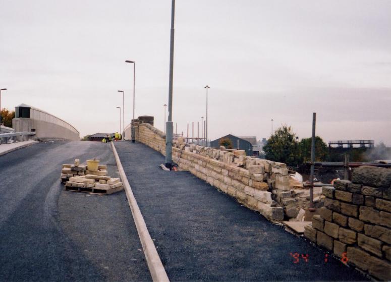 Fnishing works -stone walls barriers being installed.