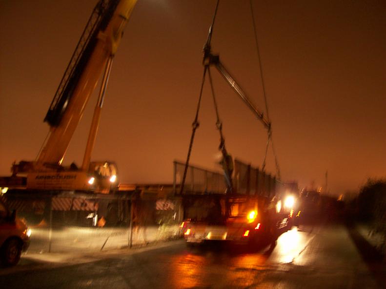 Crane off loading the bridge centre span in the Yard