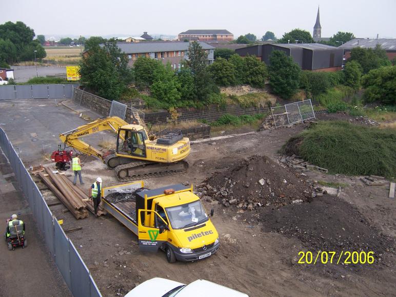 Sheet piles on site - the excavator fitting out the hammer ready for piling.