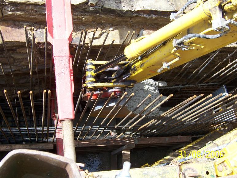 Concrete being placed with an excavator 