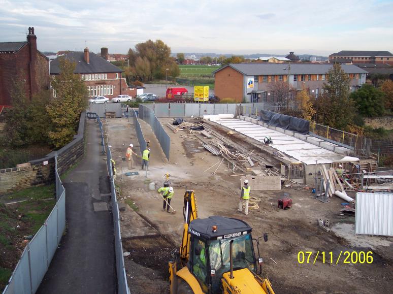 Formwork being removed from the deck end. Fence being moved to enable the services to be accessed in the old footpath.