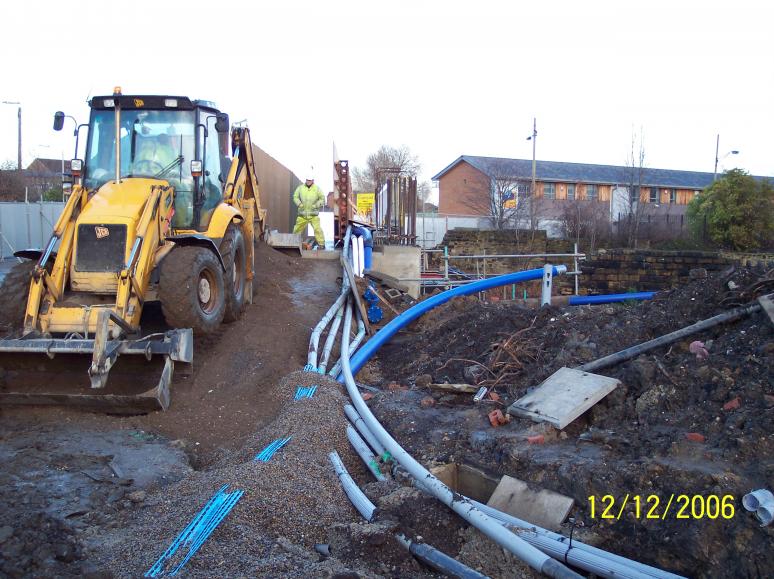 Ramps being created onto the deck - services diverted onto the deck. Temporary watermain feed being set up not the valves.