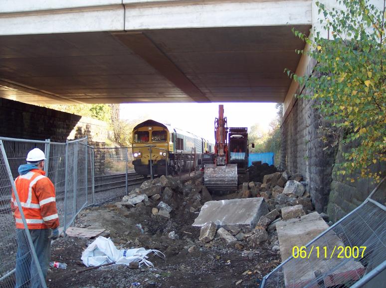 Work progressing to clear up under the bridge during normal working.