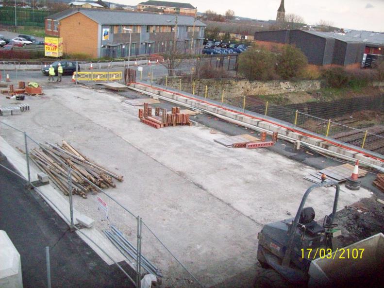 Temporary works hoarding walkway being removed.