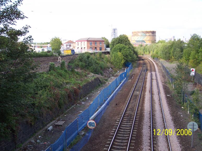 Cable trough and fence installed at track level.