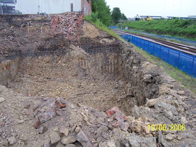 North abutment dig behind the existing stone wall.