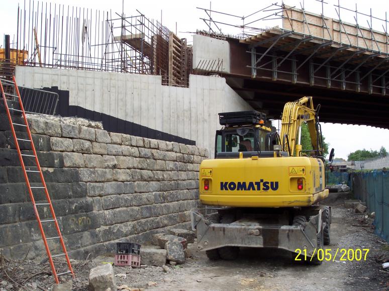 Stone faced abutment being reconstructed.