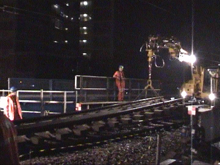 Track being lifted by bridge