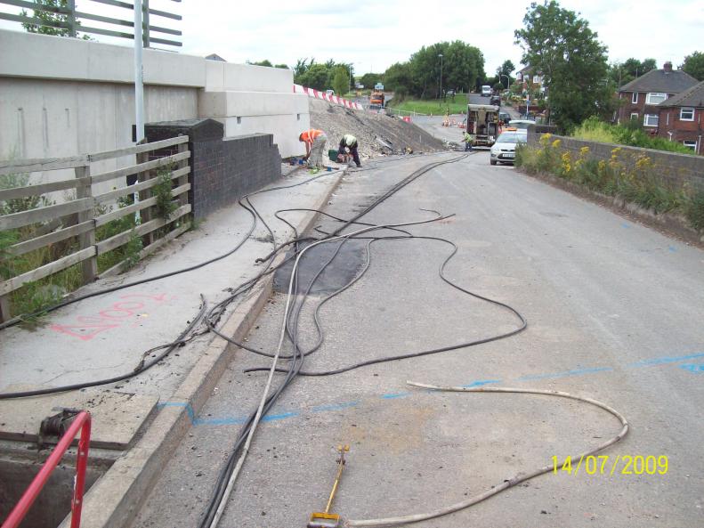 Cables and services previously diverted onto the new bridge - old cables being recovered.