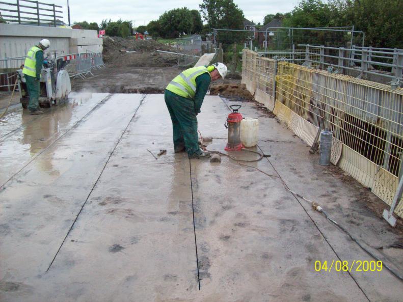 Deck being cut up and holes for chains being drilled.