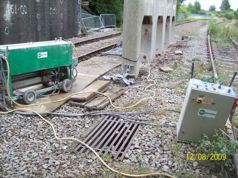 Holemasters using a band saw to cut the legs