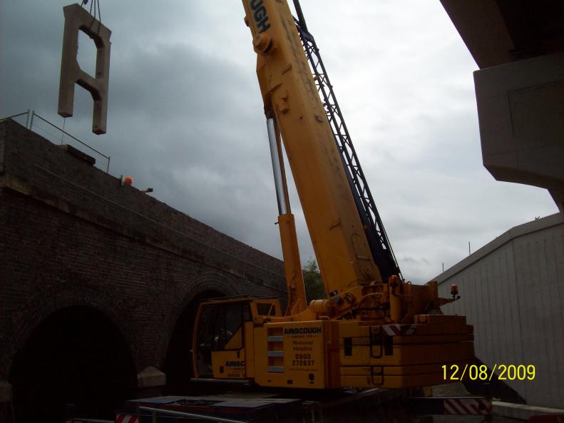 Crane lifting the first set of legs to the laydown area