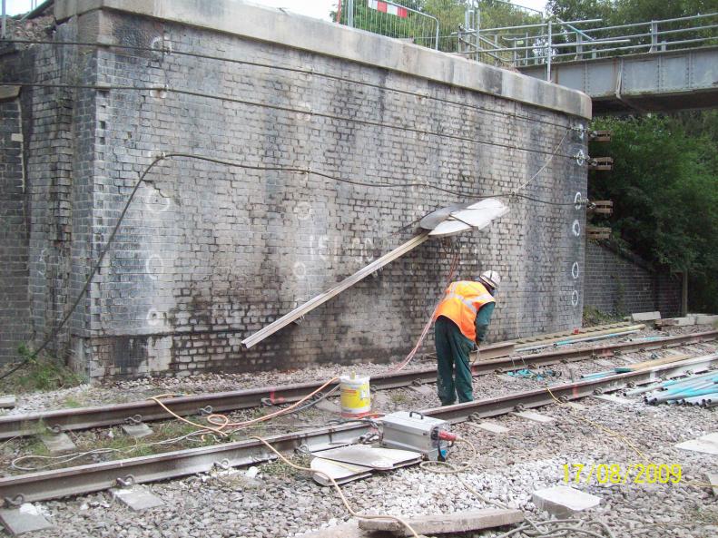 Holemasters installing a wall saw to cut the brickwork.