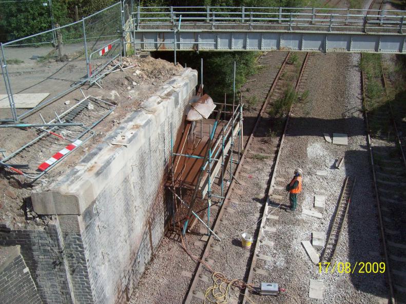 Scaffold set up with wall saw cutting the top section.