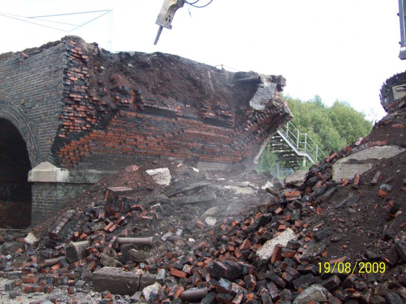 Arch span being broken down ash fill core can be seen.