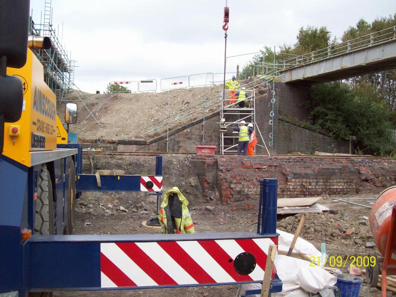 Crane lifting in stone copings reclaimed from the bridge parapets