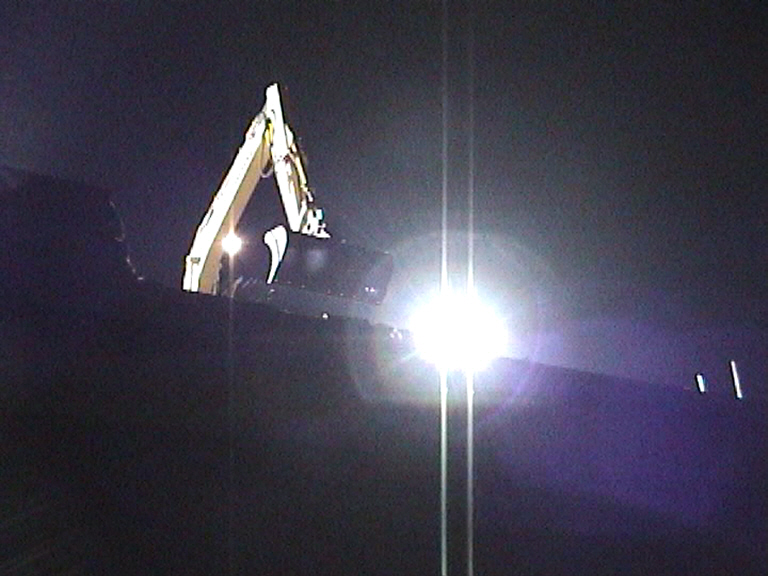 Brick parapet being removed by excavator