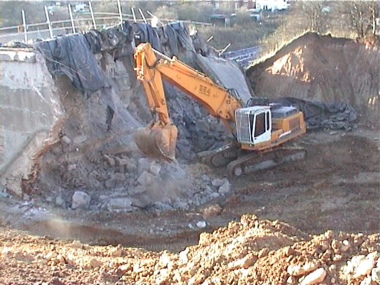 Machine demolition breaking down the abutment